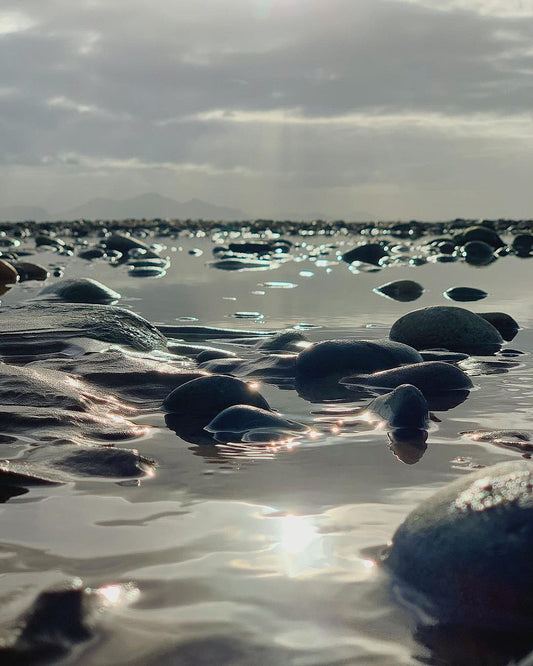 Beach Rocks, Wet pebbles and low sun on the shore, original fine-art photograph
